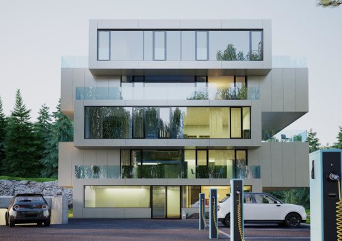 Et veldig moderne og lyst hus med stor vindusflater. Skog i bakgrunnen.