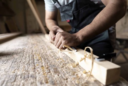 carpenter-cutting-mdf-board-inside-workshop