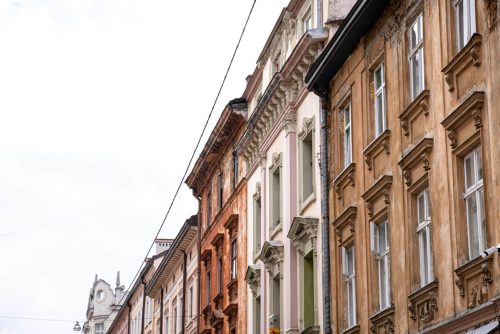 Facades of old houses in a row against the sky, old architecture, copy space.